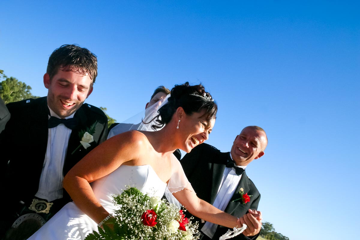 Megs and Russ against a blue sky after their wedding.