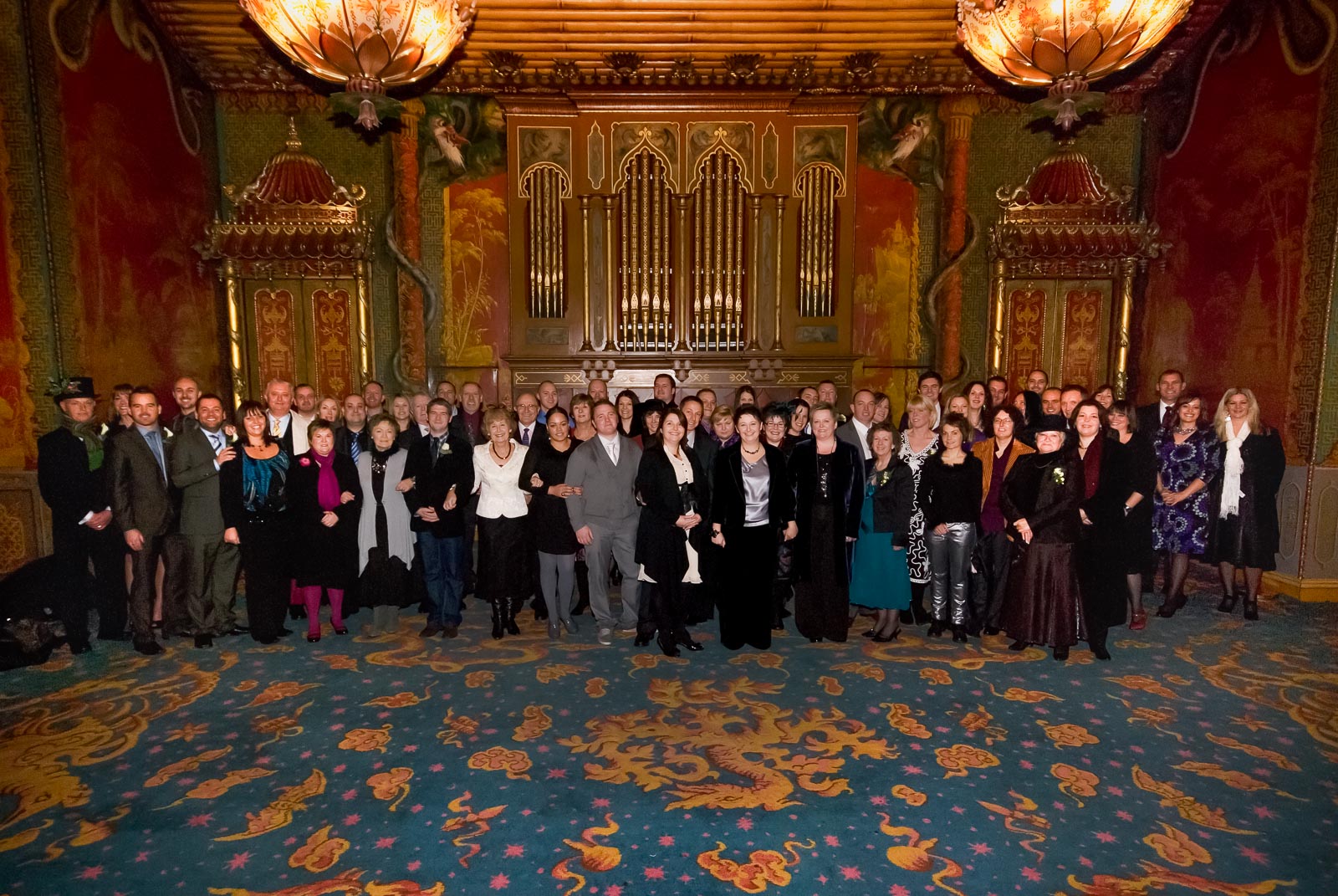 Laura, Paula and their wedding guests pose inside Brighton Dome after their civil partnership.