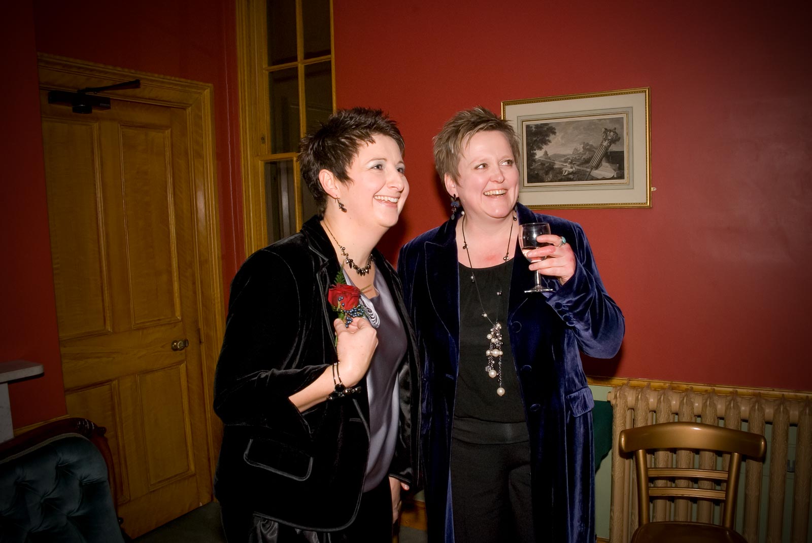 Laura and Paul have a glass of champagne inside Brighton Dome before their civil partnership.