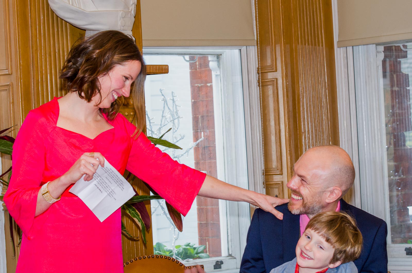 Annie touches Mark's shoulder during a speech at their wedding in Lewes Town Hall.