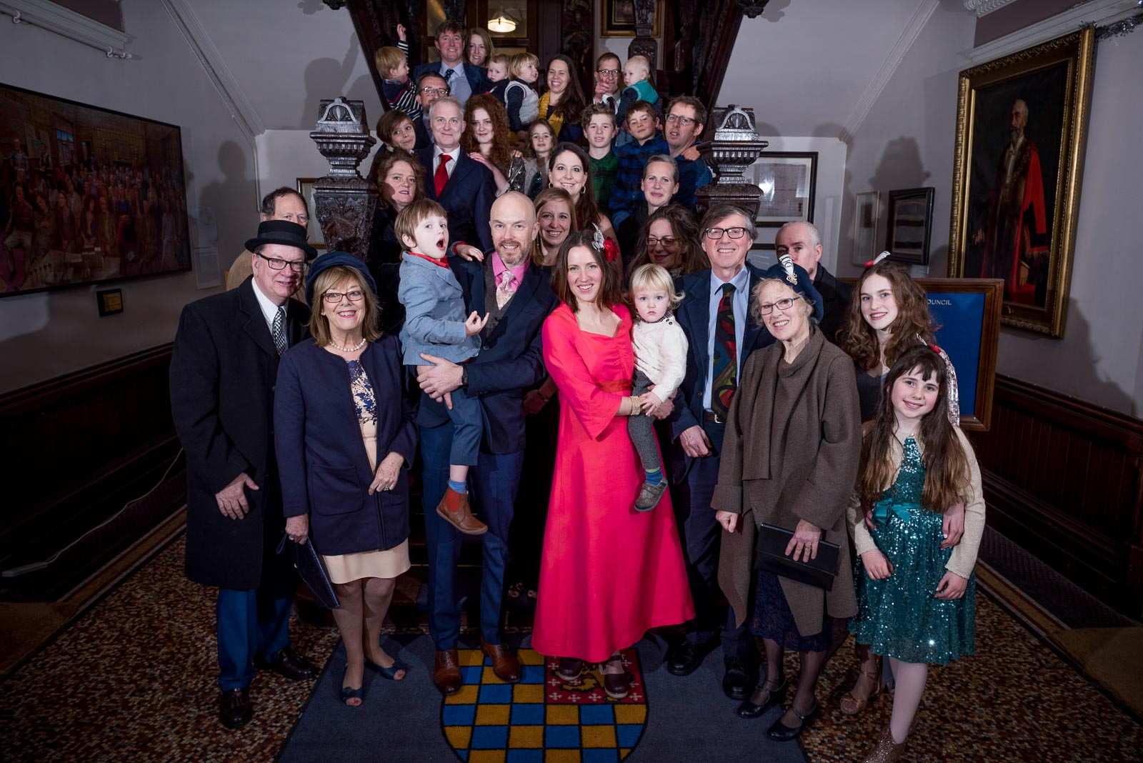 Annie. Mark and their wedding guests pose for a group photo on the stairs at Lewes Town Hall.