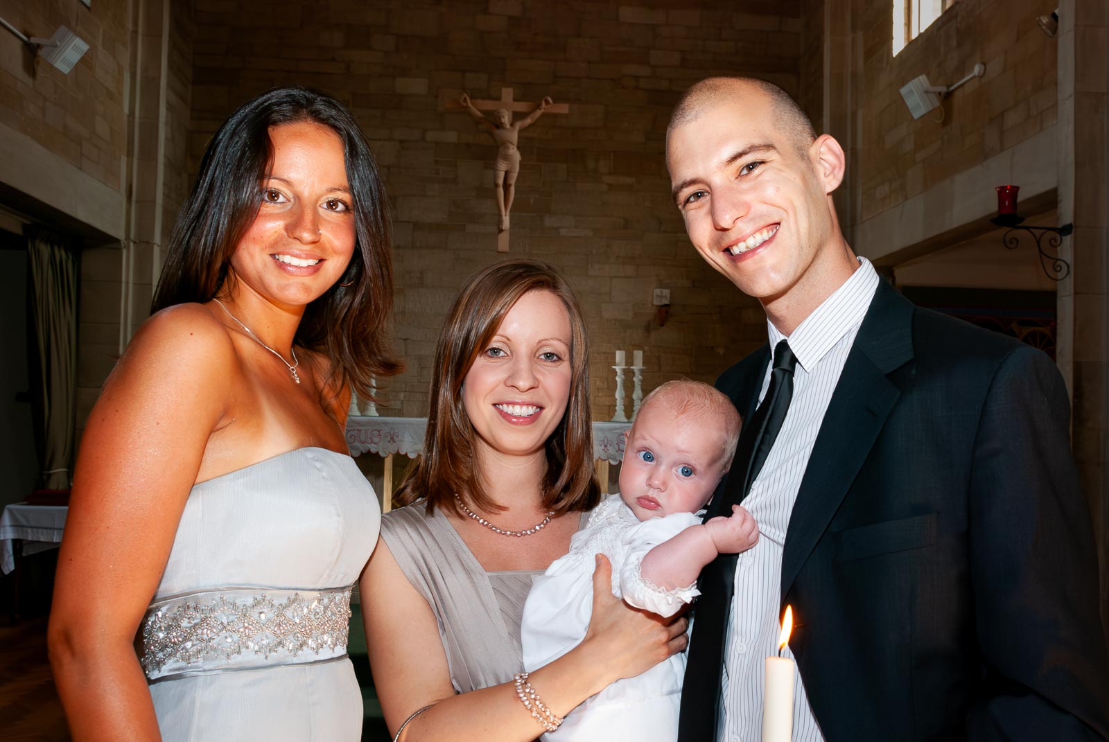 Amalie and her mum and god parents pose in the church after her baptism.