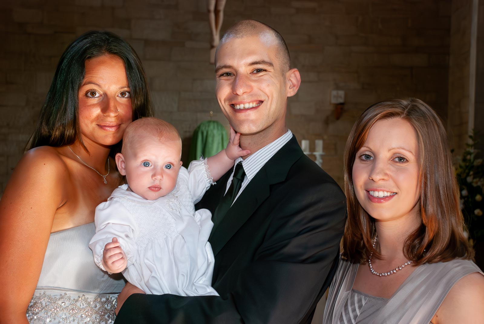 Amalie and her mum and god parents pose in the church after her baptism.