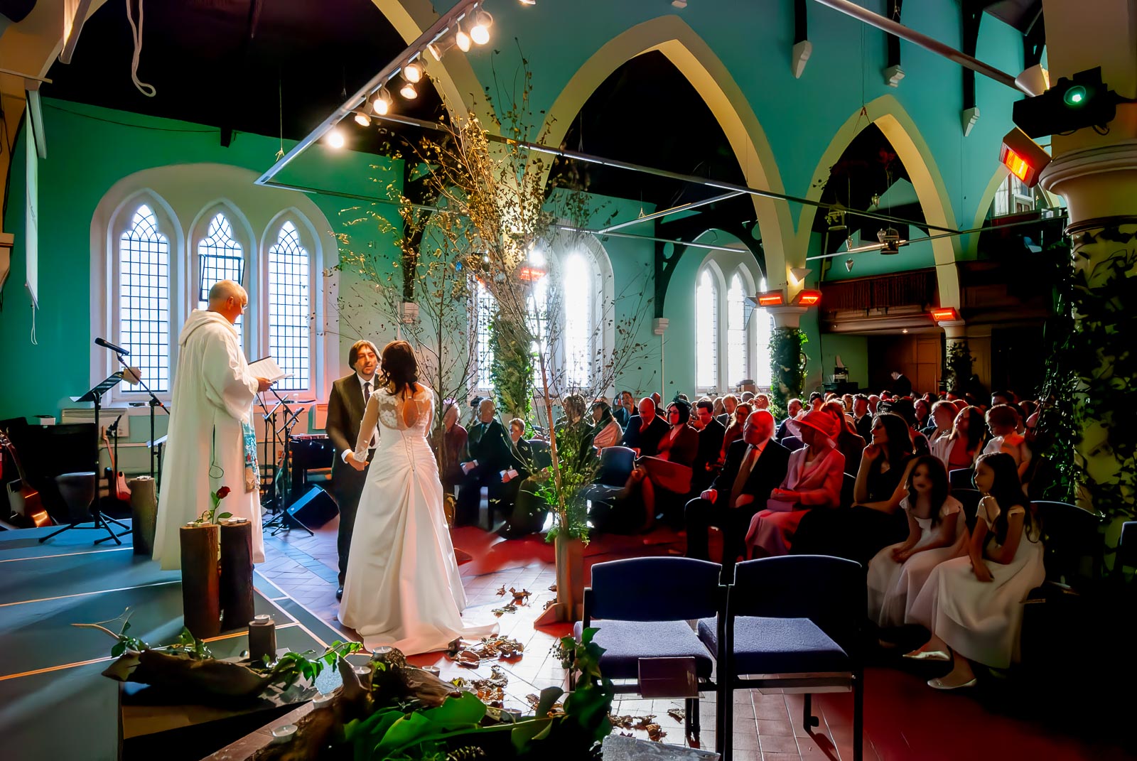 Jon and Lou give their vows during their wedding at St Michaels Church in Brighton.