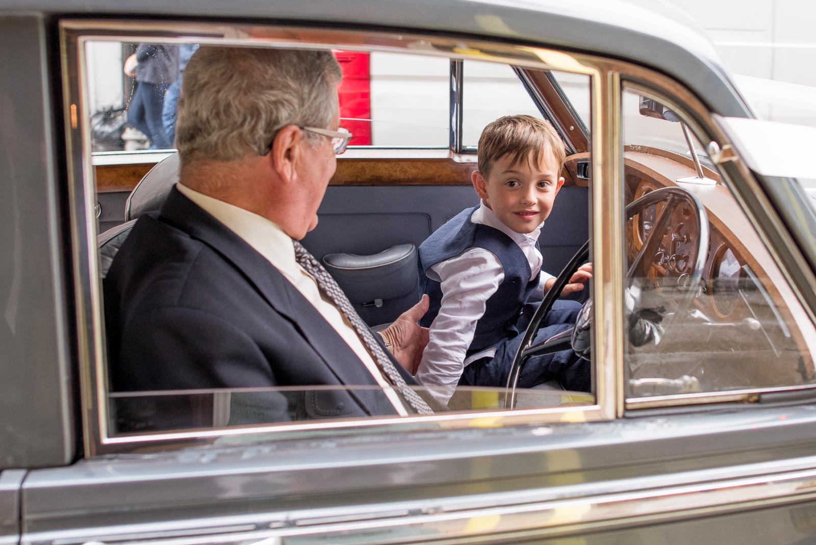Emily and Richard's son looks through the window of theiw wedding car at Lewes Town Hall.
