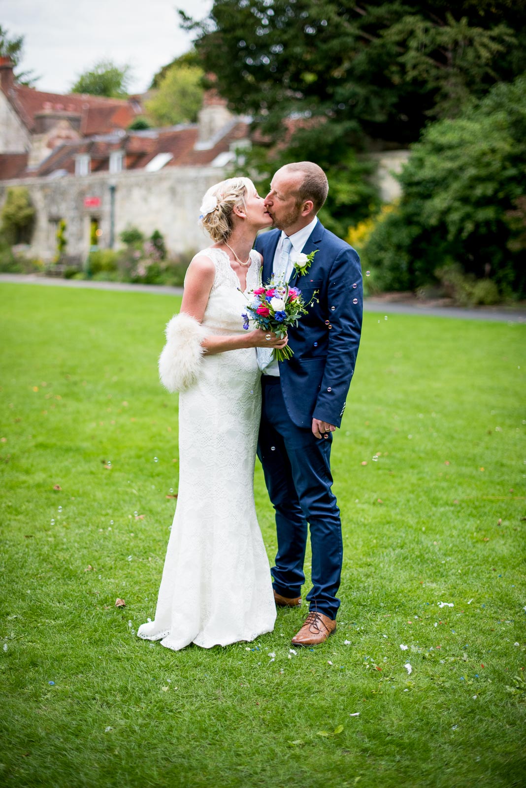 Emily and Richard embrace in Southover Grange, Lewes after their wedding.