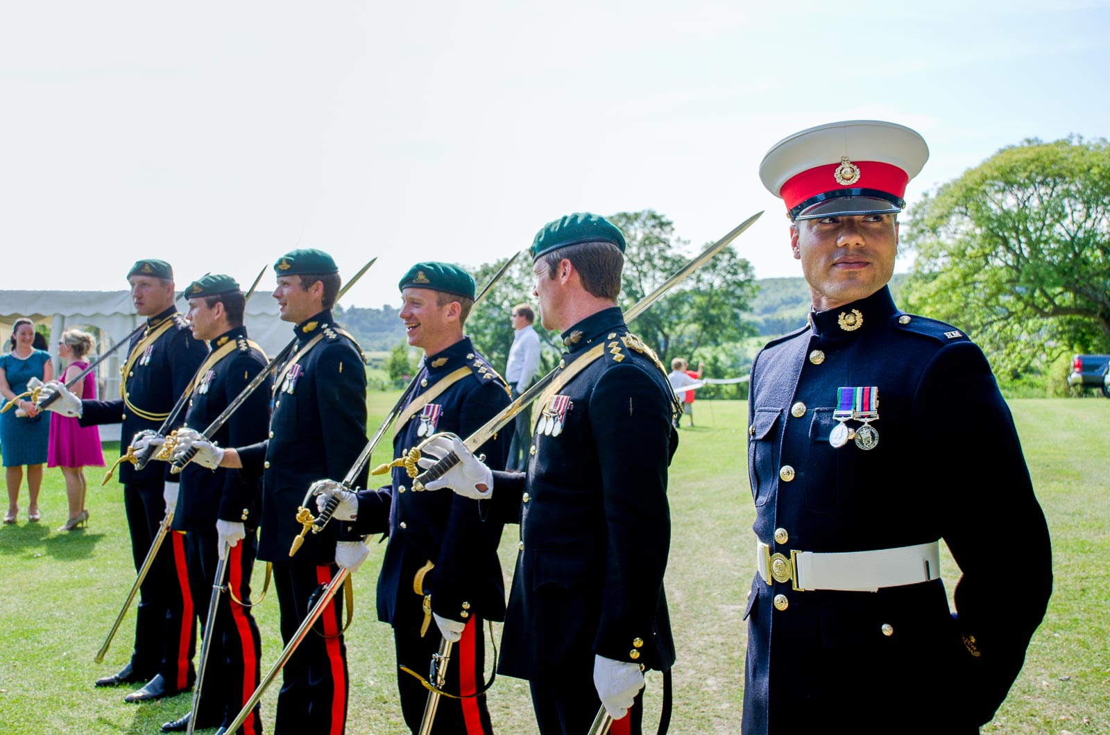 Members of the saber arch wait for Racael and Dan to arrive at their wedding reception at Burpham Village Hall.