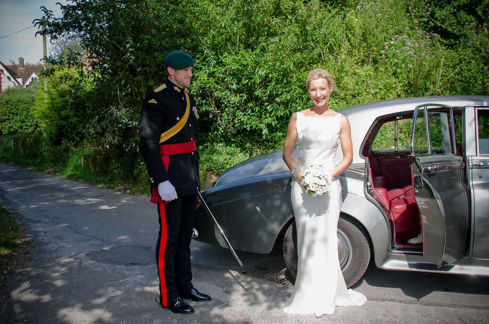 Rachael and Dan arrive at their wedding reception at Burpham Village Hall in a vintage Rolls Royce.