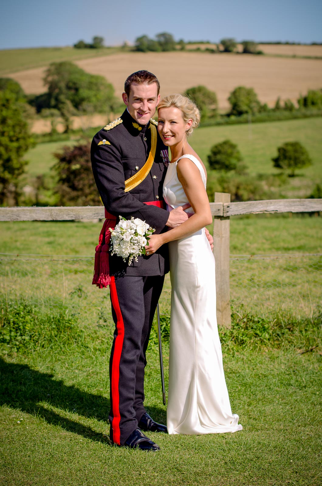 Rachael and Dan pose on front of the South Downs during their wedding reception wedding reception at Burpham Village Hall.