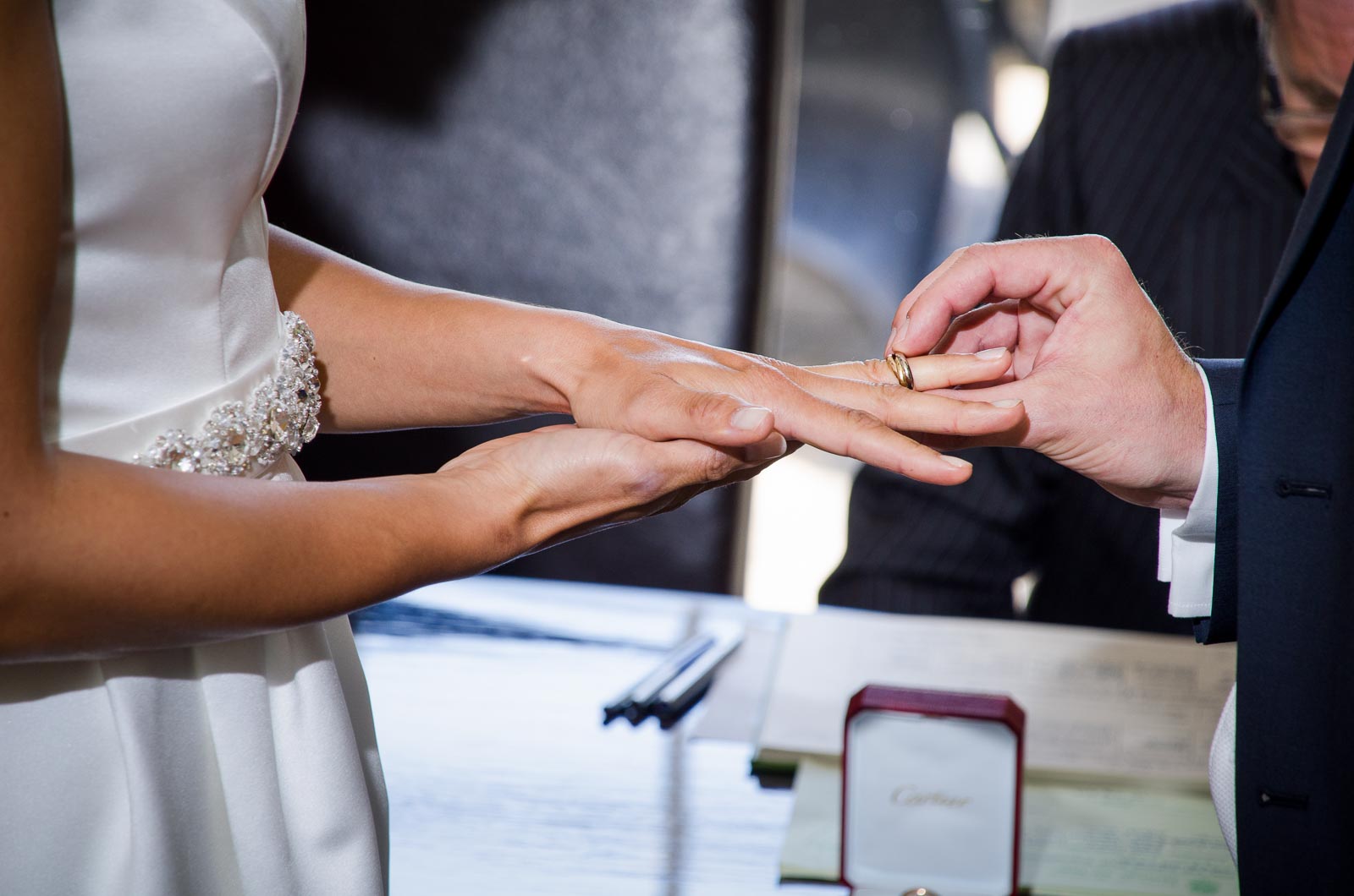 Raf places a wedding ring on Tash's finger during their wedding reception in Borde Hill, Haywards Heath.