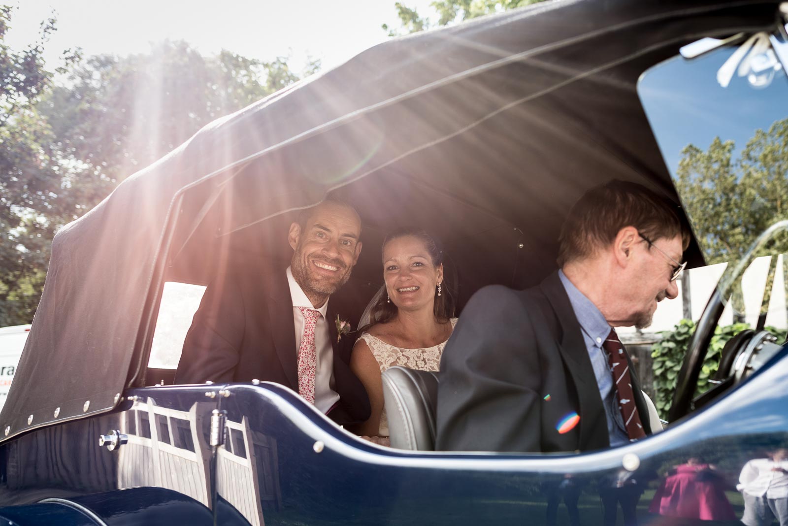 Donna and Andy photographed in the wedding car arrive at their wedding reception .