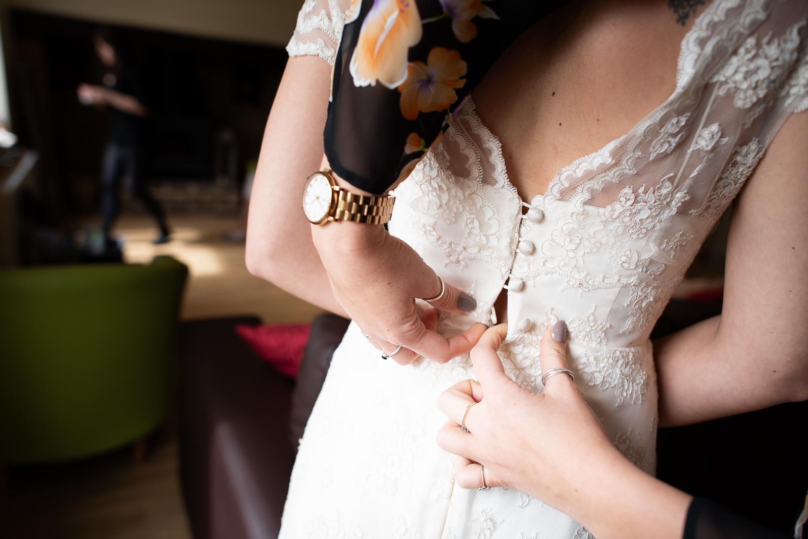 Toni has her dress buttoned done in the farmhouse at Nutley Edge before her wedding.