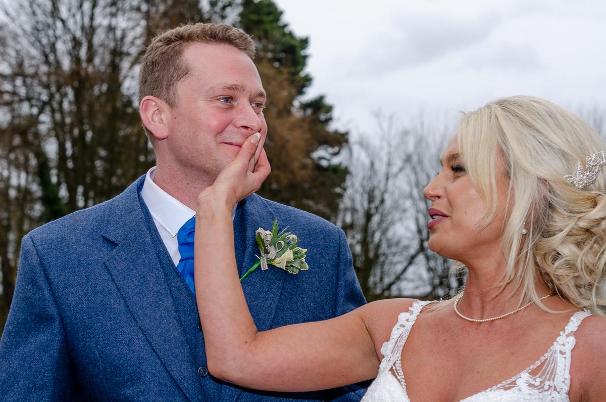 Eilidh wipes lipstick from Lewis's face after their wedding.