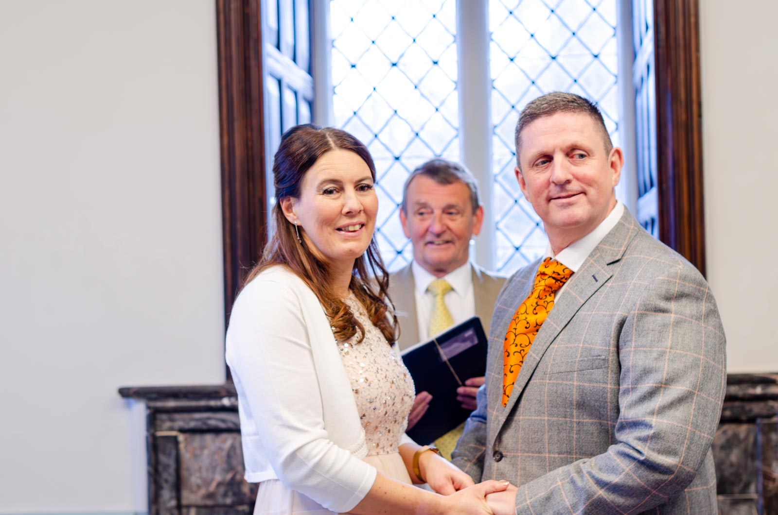 Grant and Jane look out to their wedding guests at the Evelyn Room at Lewes Register Office.