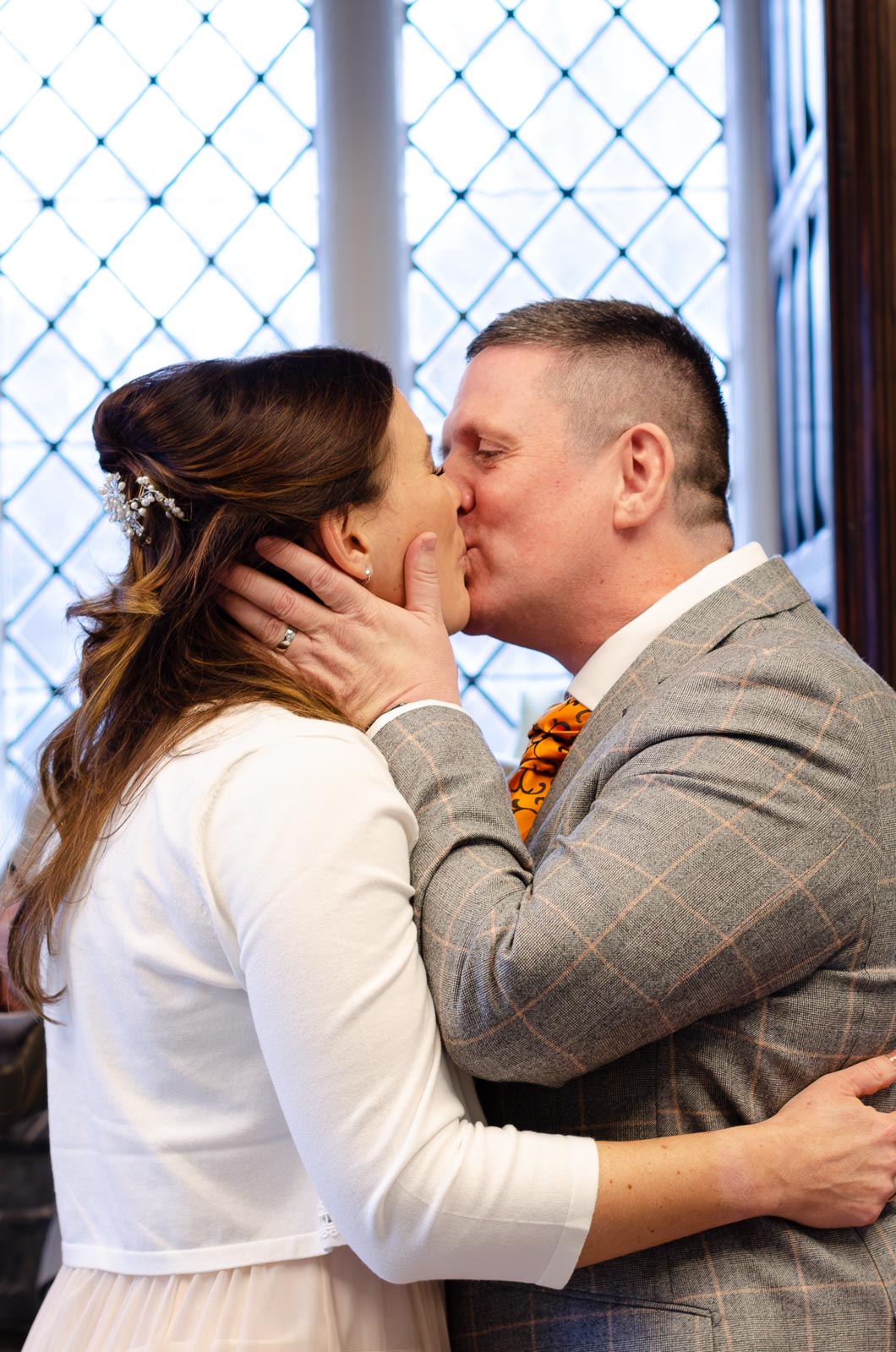 Grant and Jane embrace after becoming husband and wife at the Evelyn Room at Lewes Register Office.