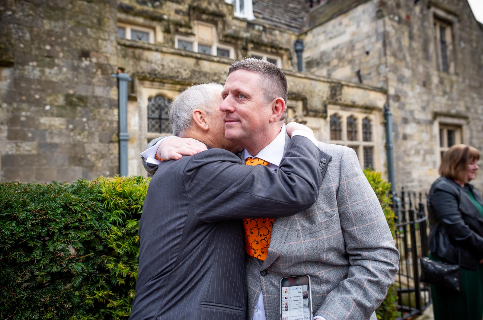 Grant is greeted by wedding guests outside Lewes Register Office before his wedding to Jane.