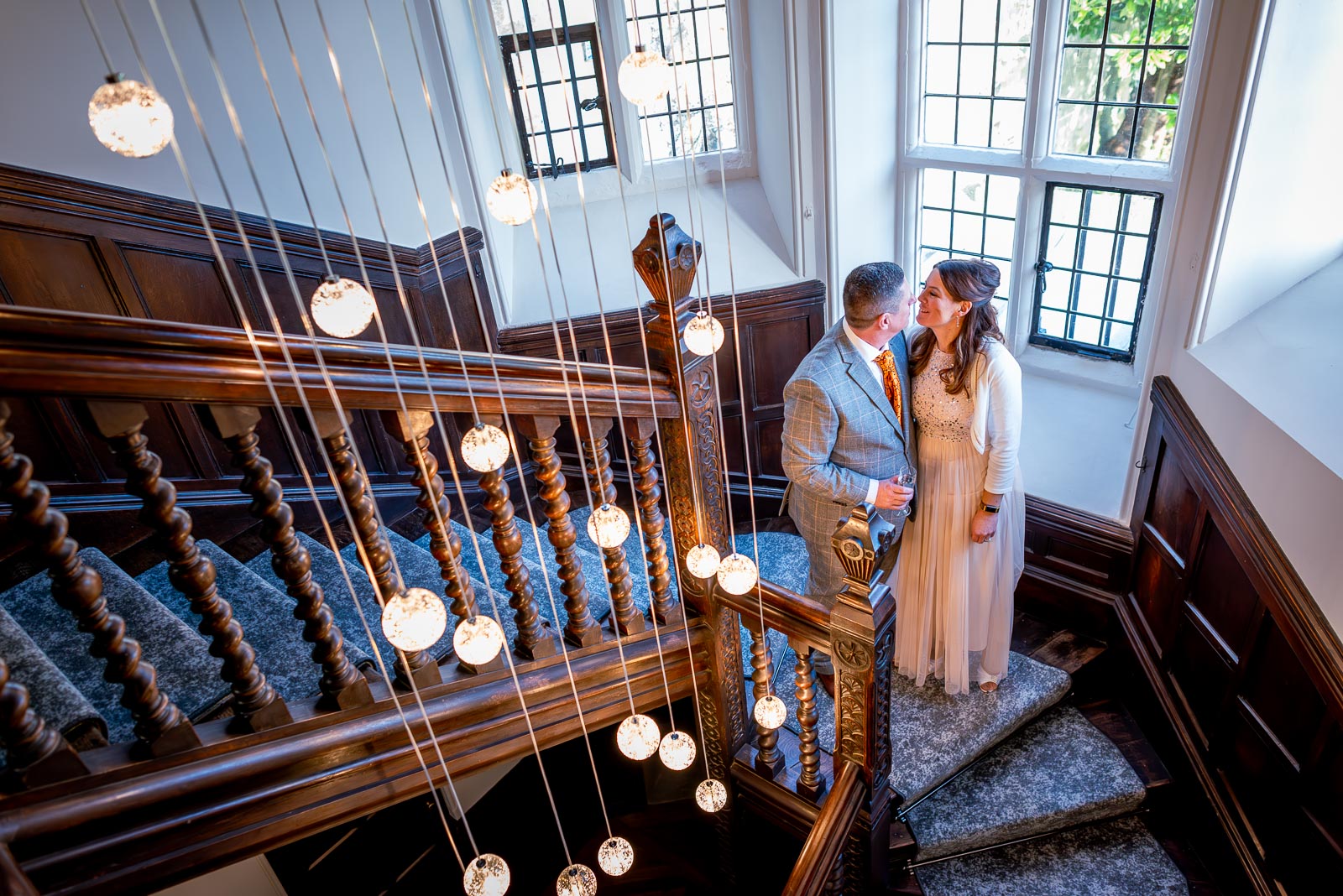Grant and Jane look at eachother on the stairs at Lewes Register Office.