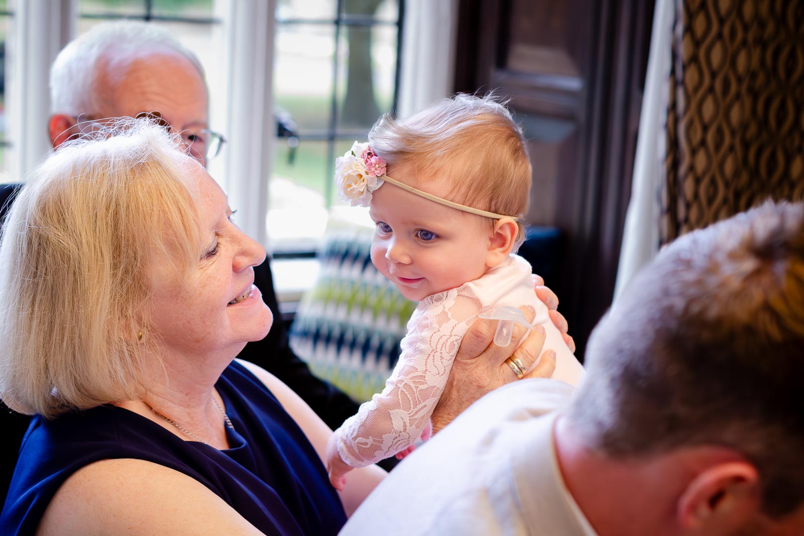 A young wedding guest smiles in the Ainsworth Room at Lewes Register Office.