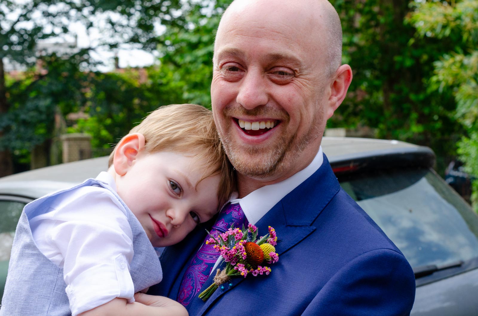 Ben smiles woth his young son in his arms outside Lewes Register Office before his wedding to Katherine.