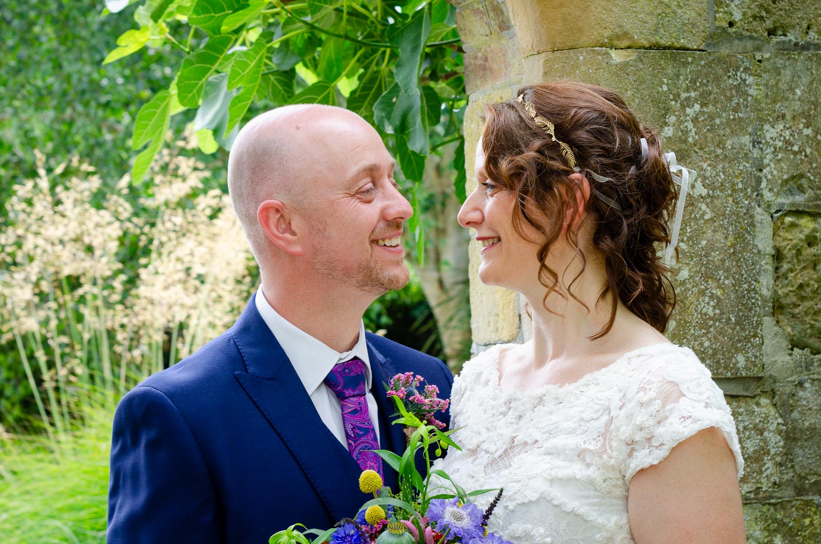 Katherine and Ben smile at eachother in Southover Grange after their wedding at Lewes Register Office.
