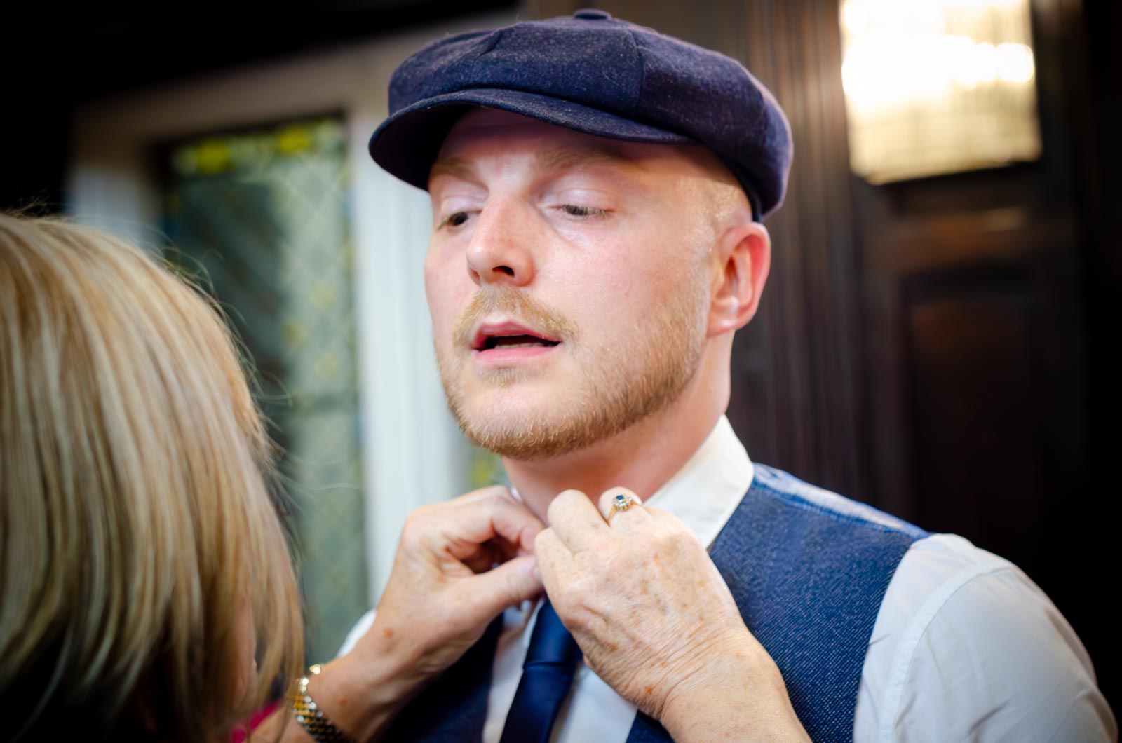 An usher is helped with his tie in Lewes Register Office.