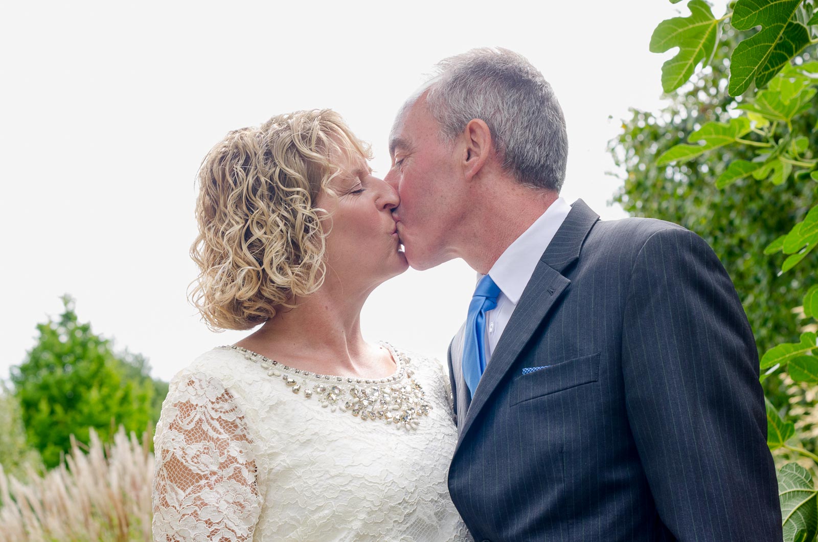 Wendy and Chris kiss in Southover Grange after their wedding at lewes Register Office.