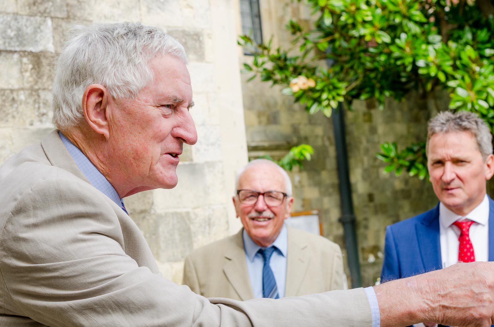 A wedding guest charges a toast to Wendy and Chris in Southover Grange after their wedding at lewes Register Office.