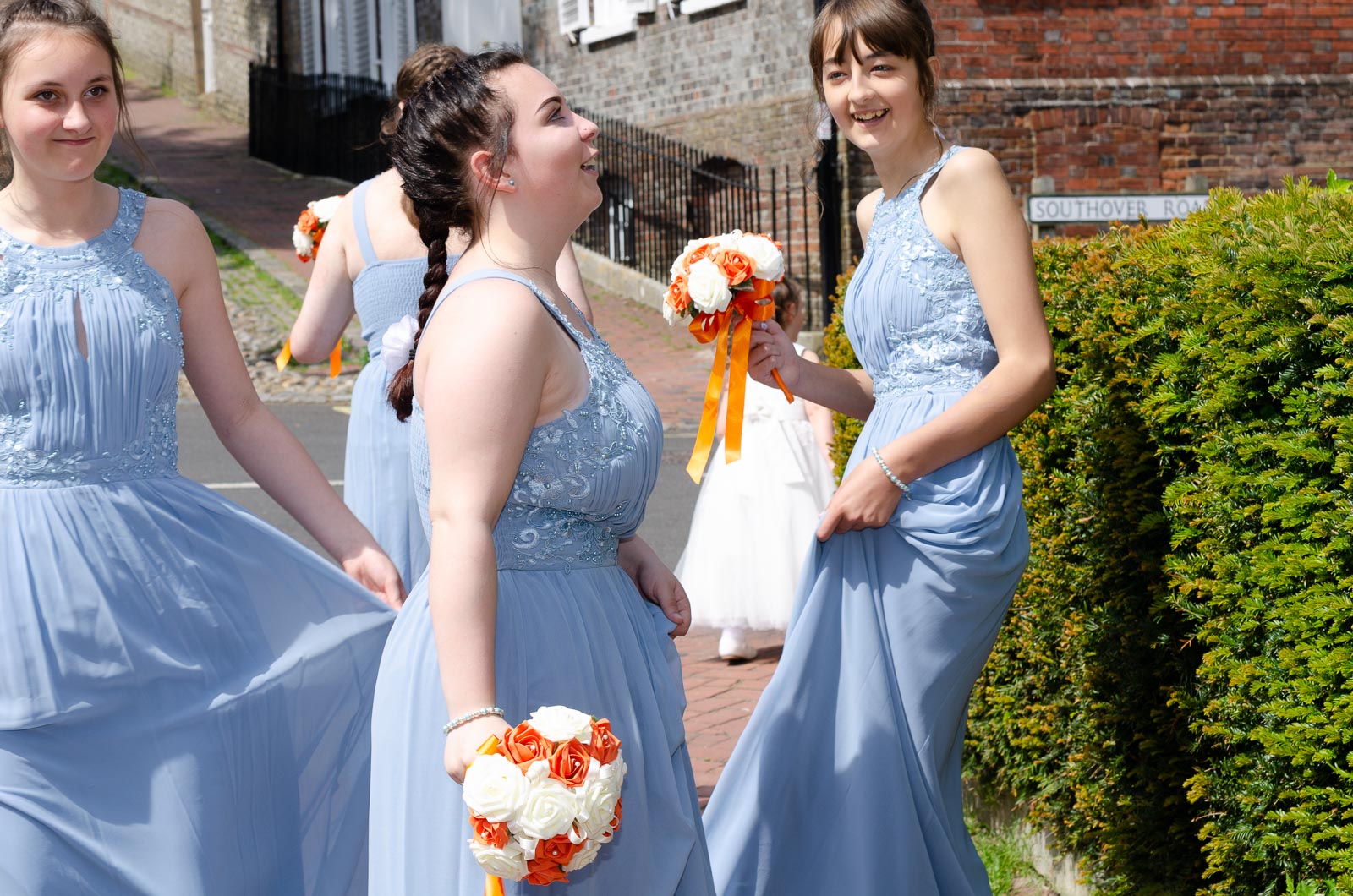 Bridesmaids laugh outside Lewes Registry Office.