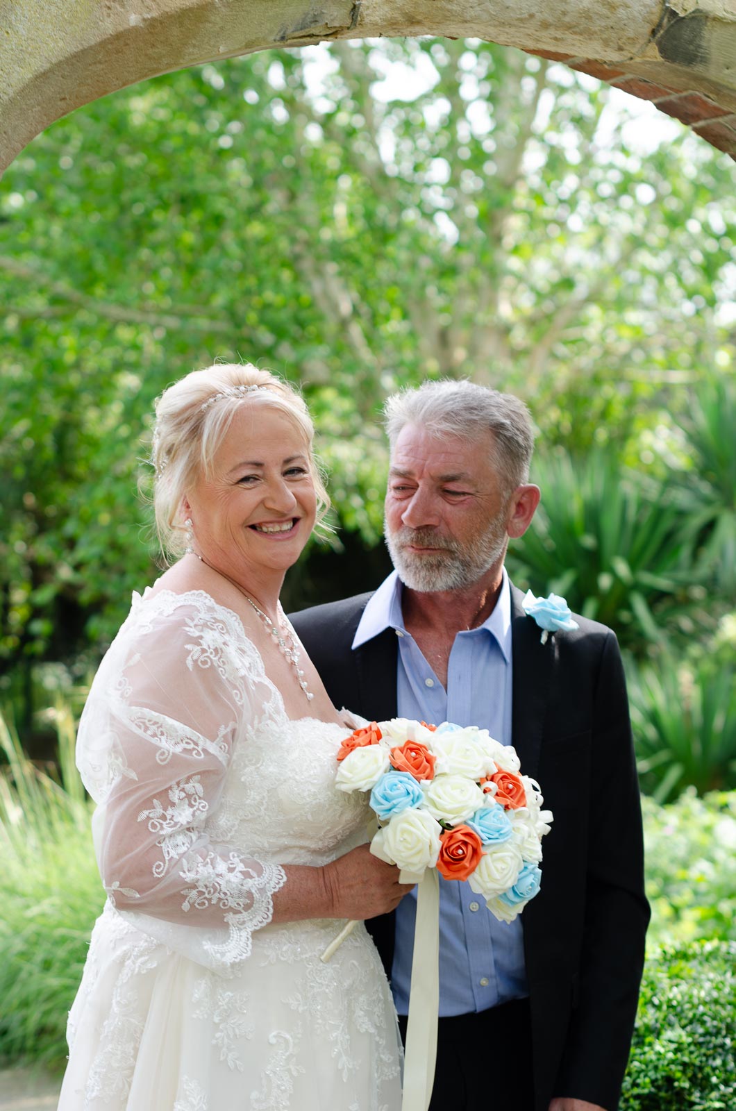 Jason look at Wendy who engages with the camera in Southover Grange, Lewes after their wedding.