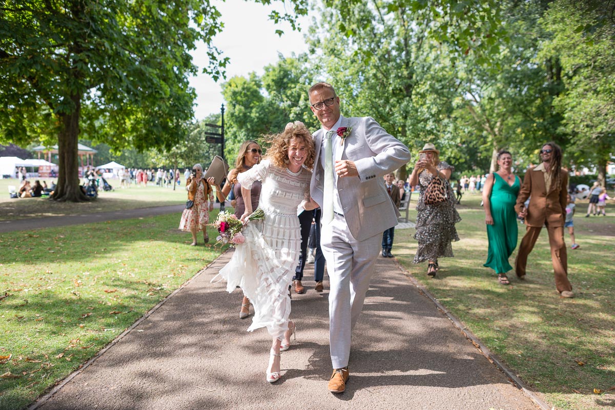 Kitty and Will dance to the wedding venue after their wedding at Queens Park London.