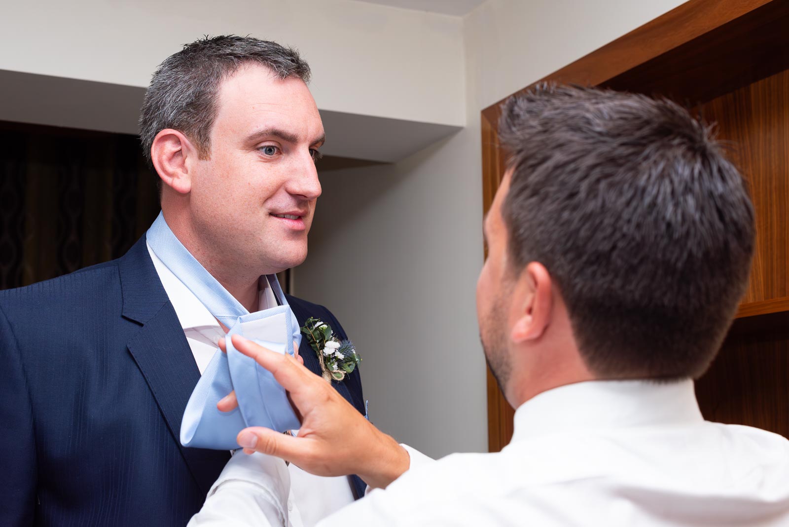 Ally gets a bit of helping with his neck tie before his wedding to Jane at Grand Hotel, Eastbourne.