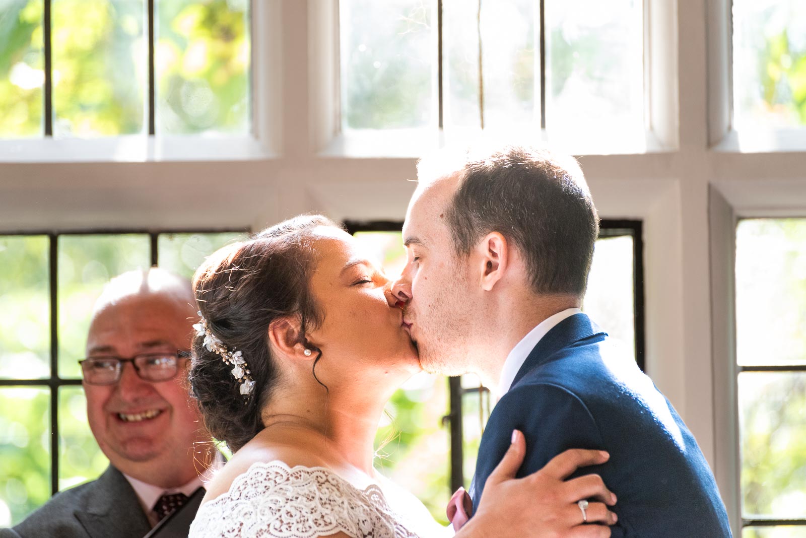 Amy and James embrace in the Ainsworth Room in Lewes Register Office during their wedding.