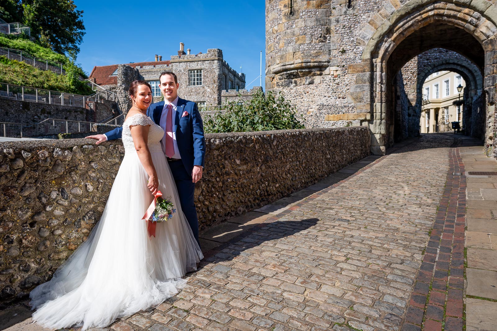 Amy and James pose outside Lewes Castle after their Wedding.