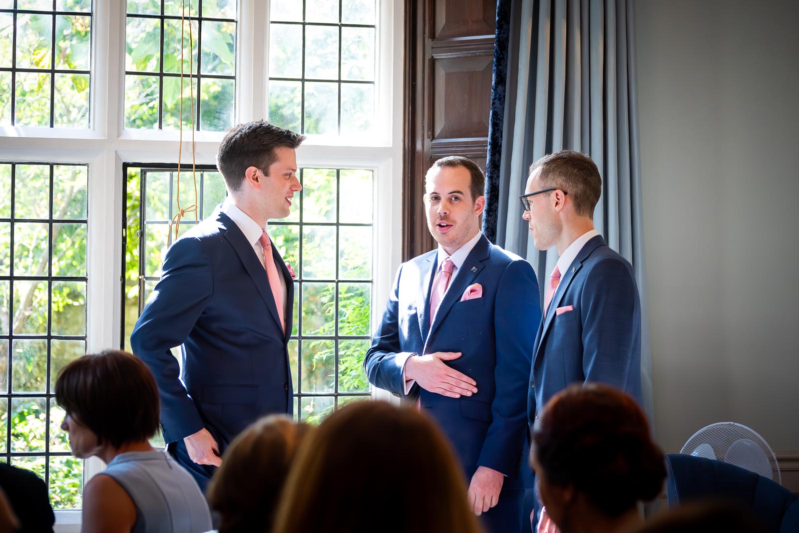 James waits at the top of the aisle in the Ainsworth Room in Lewes Register Office with his best men before his wedding to Amy.