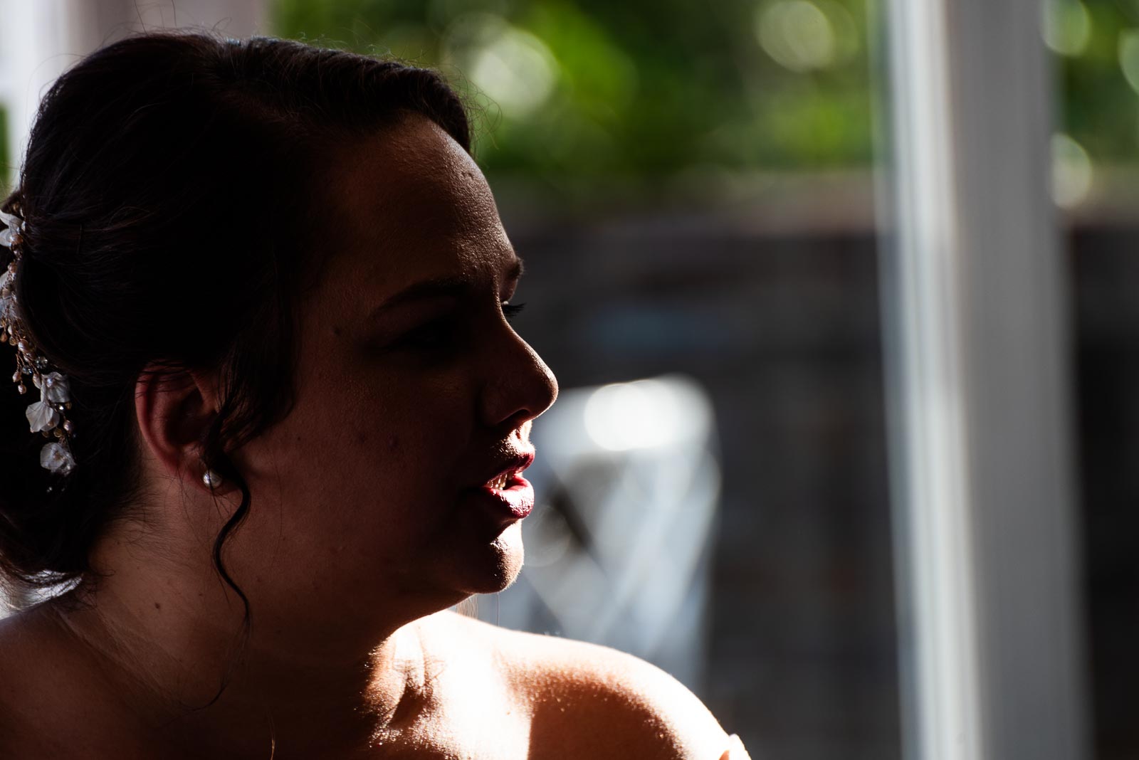 Amy is highlighted by backlight at her wedding breakfast in The White Hart Hotel, Lewes.