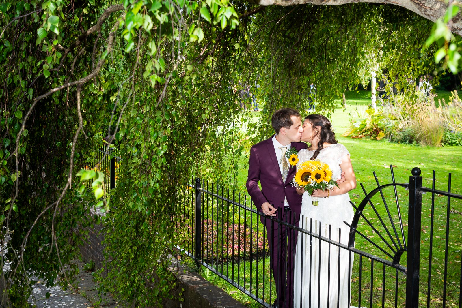 Ashley and Anjana embrace in Southover Grange, Lewes after their wedding.