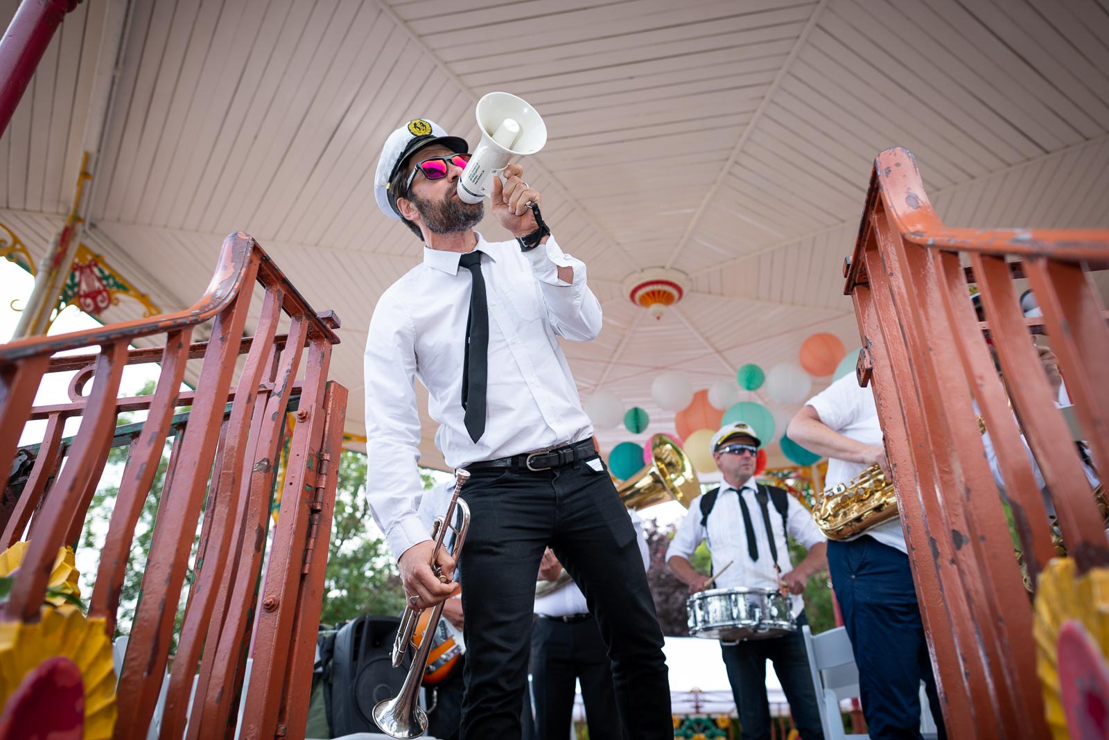 The wedding band play their first number at Kitty and Will's Wedding in the Band Stand at Queens Park in London.