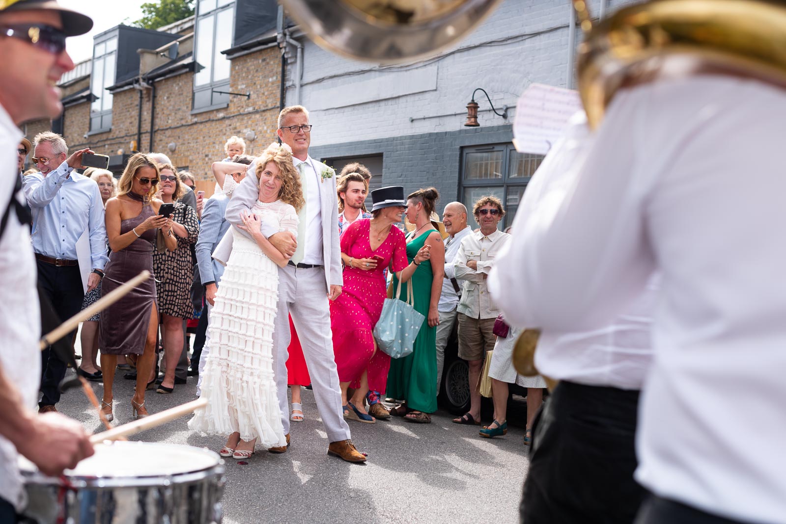 Kitty and Will enjoy listening to the band after their wedding in the Band Stand at Queens Park in London.