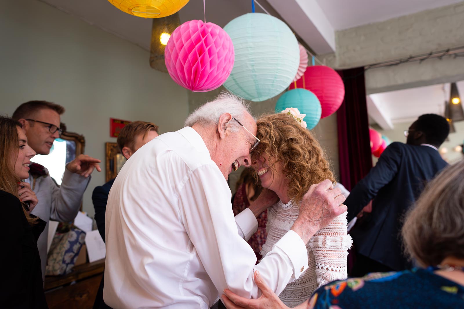 Kitty and her father enjoy a moment during her wedding reception. 