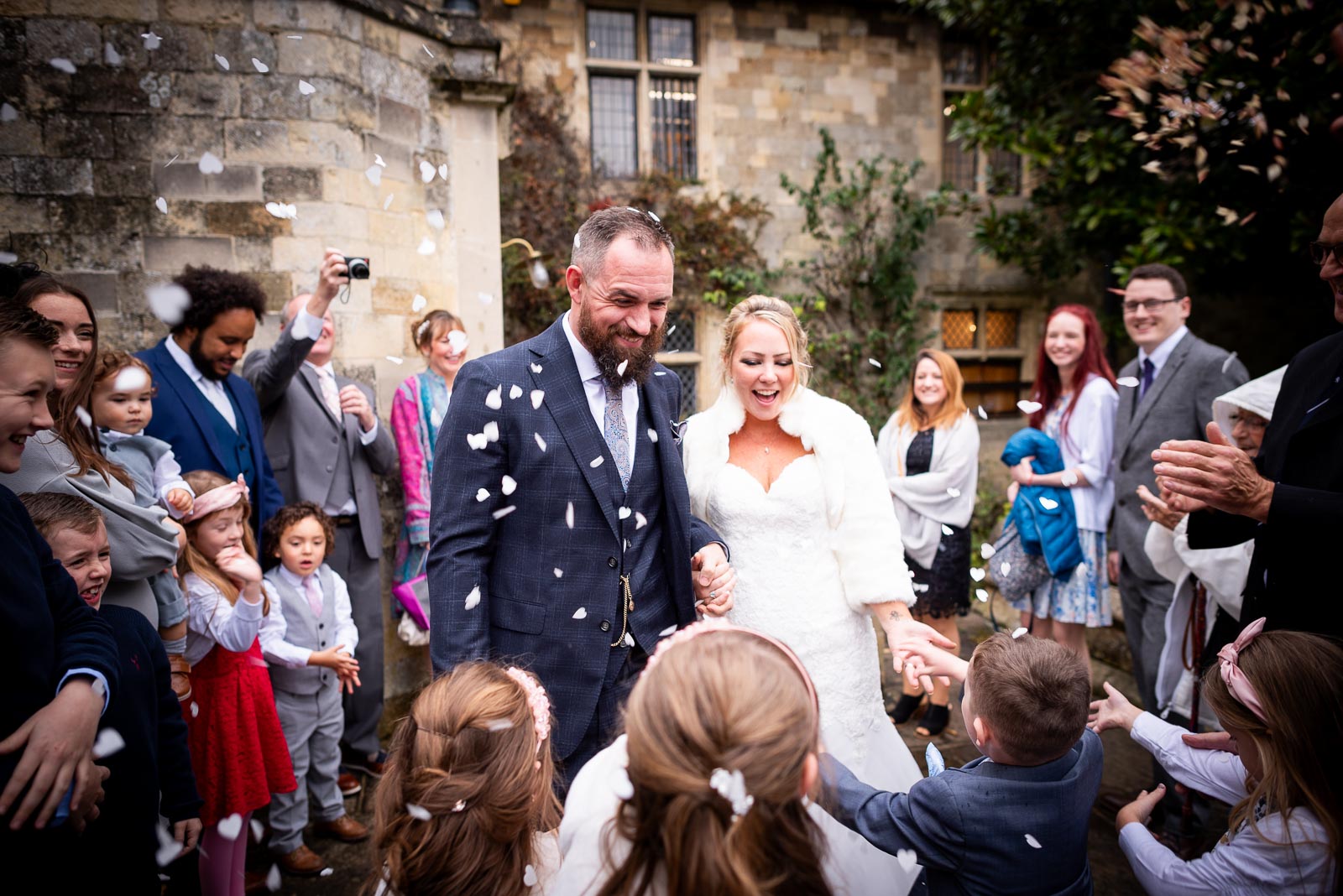 Wedding guests throw confetti at Laura and Sam in Southover Grange, Lewes.