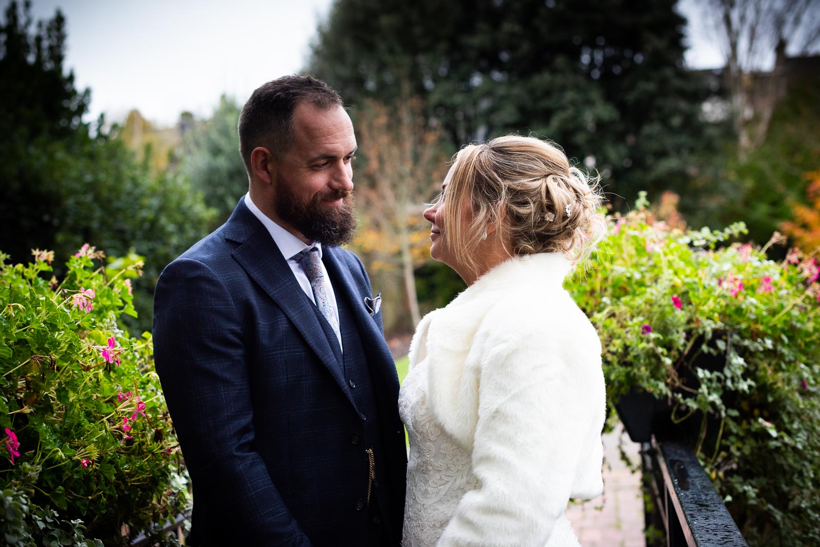 Laura and Sam look at eachother and smile in Southover Grange, Lewes after their wedding.