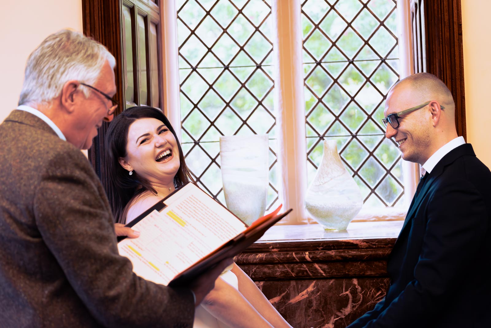 Maria laughs at the top of the aisle in the Evelyn room at Lewes Register Office during her wedding to Robert.