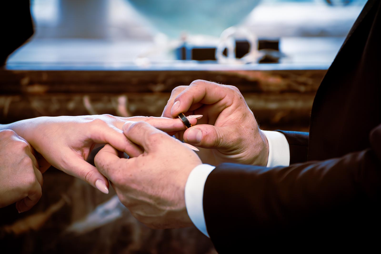 Robert places a ring on Maria's hand  in the Evelyn room at Lewes Register Office during their wedding.