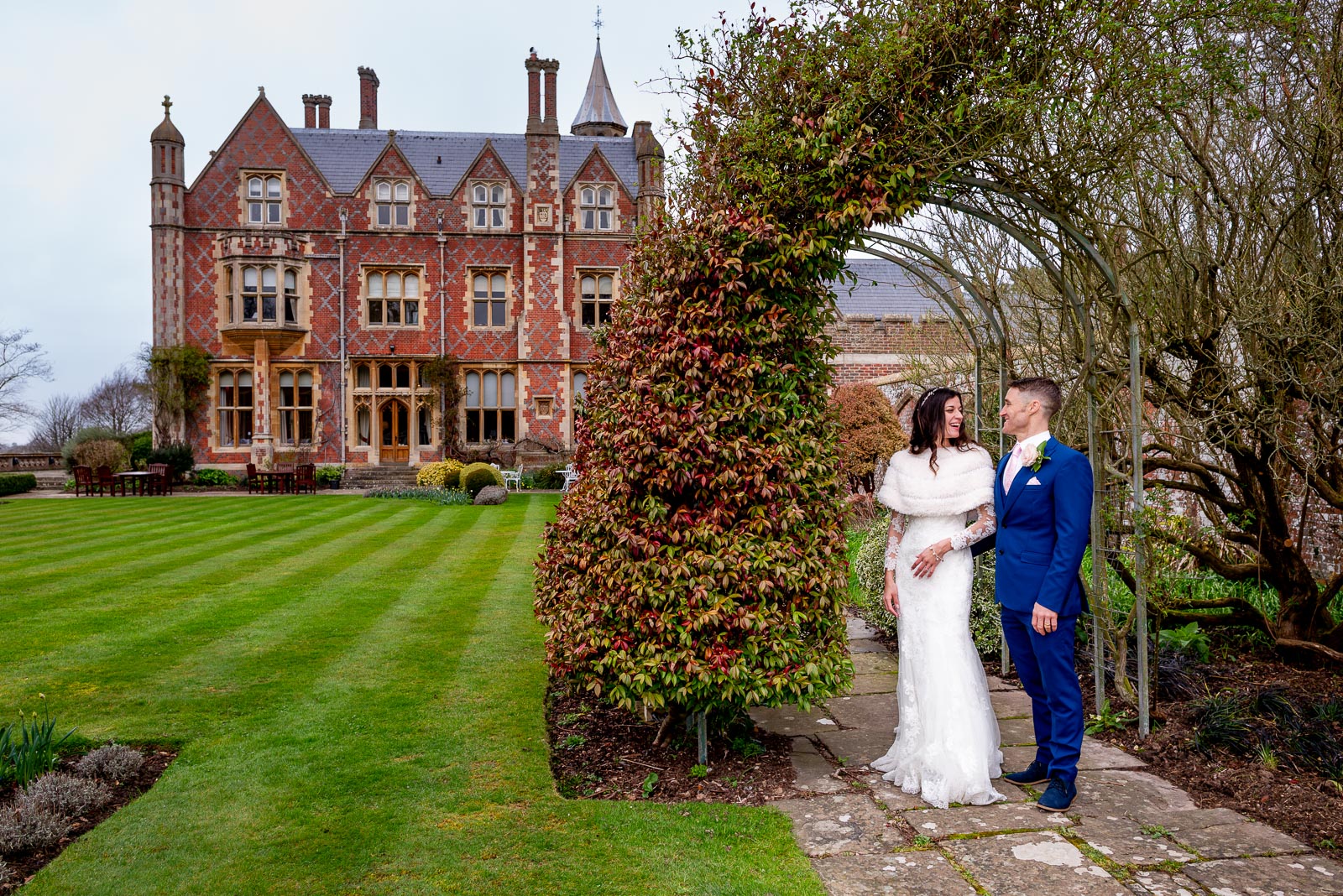 Virgina and Simon pose in the gardens at Horsted Place during their wedding reception.