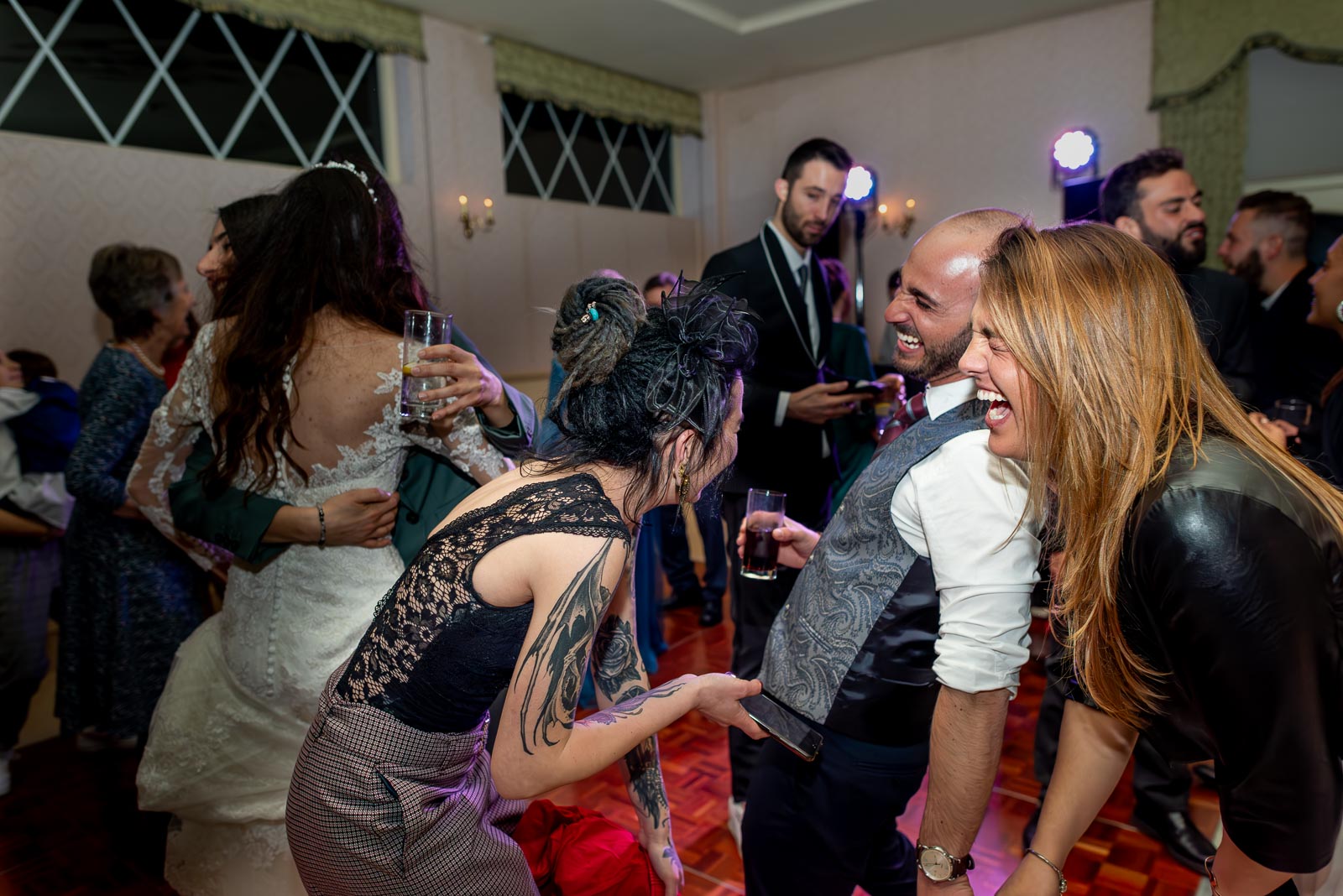 Virginia and Simon's Wedding guests laugh on the dance floor at Horsted Place Hotel.