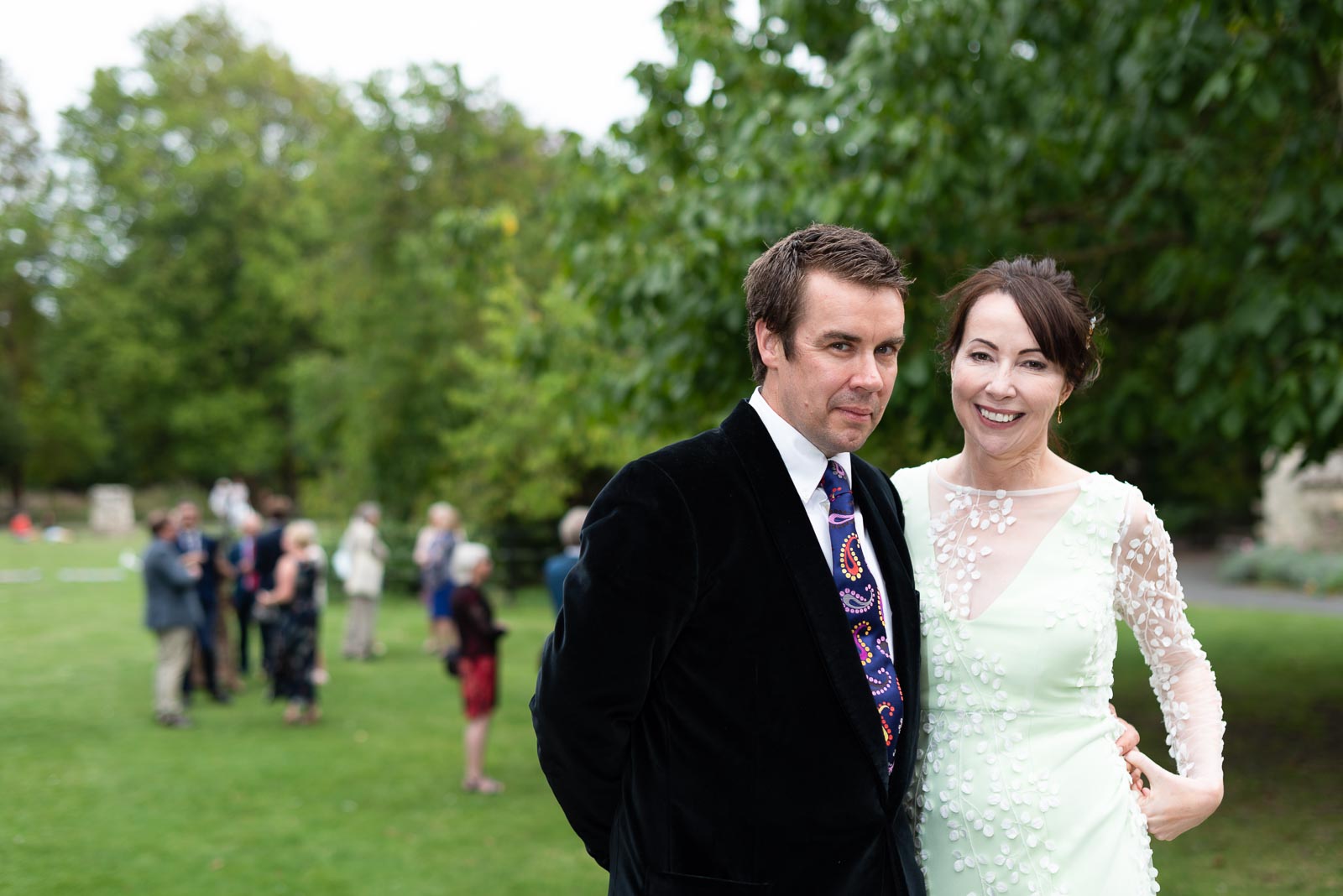 Fiona and Richard walk past their guests in Southover Grange, Lewes after their wedding.