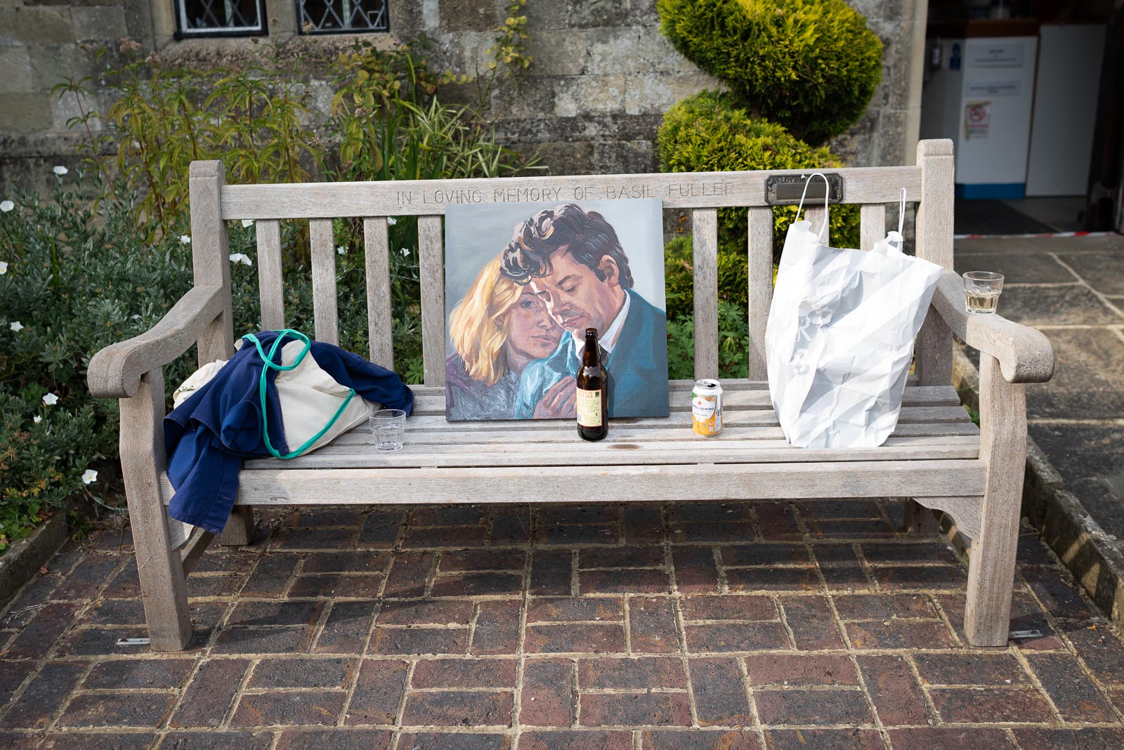 A painting of Richard and Fiona given by a guest of their wedding is displayed on a park bench in Southover Grange.