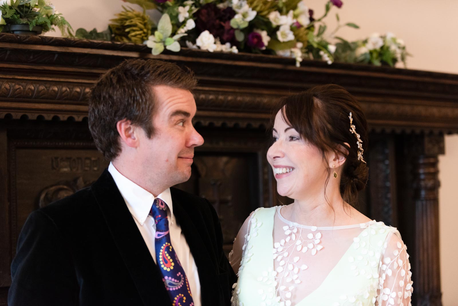 Fiona and Richard smile at each other during their wedding at Lewes Register Office.