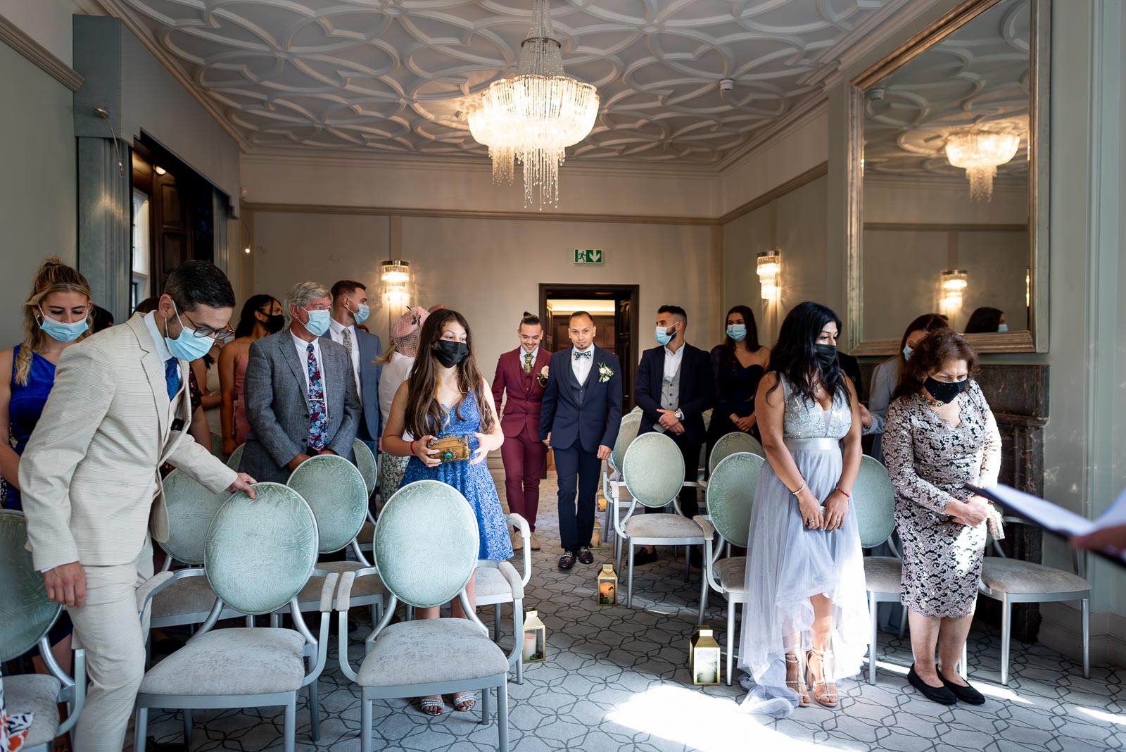 Ady and Jose walk down the aisle in the Ainsworth Room at Lewes Registry Office before their wedding. 
