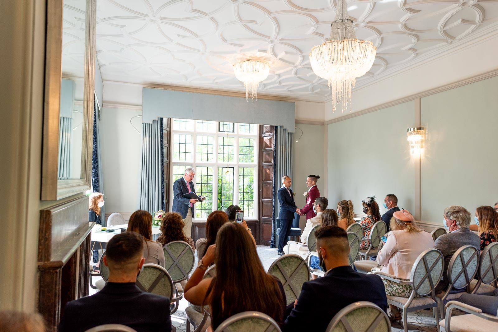 Ady and Jose face eachother whilst exchanging vows in the Ainsworth Room at Lewes Registry Office.